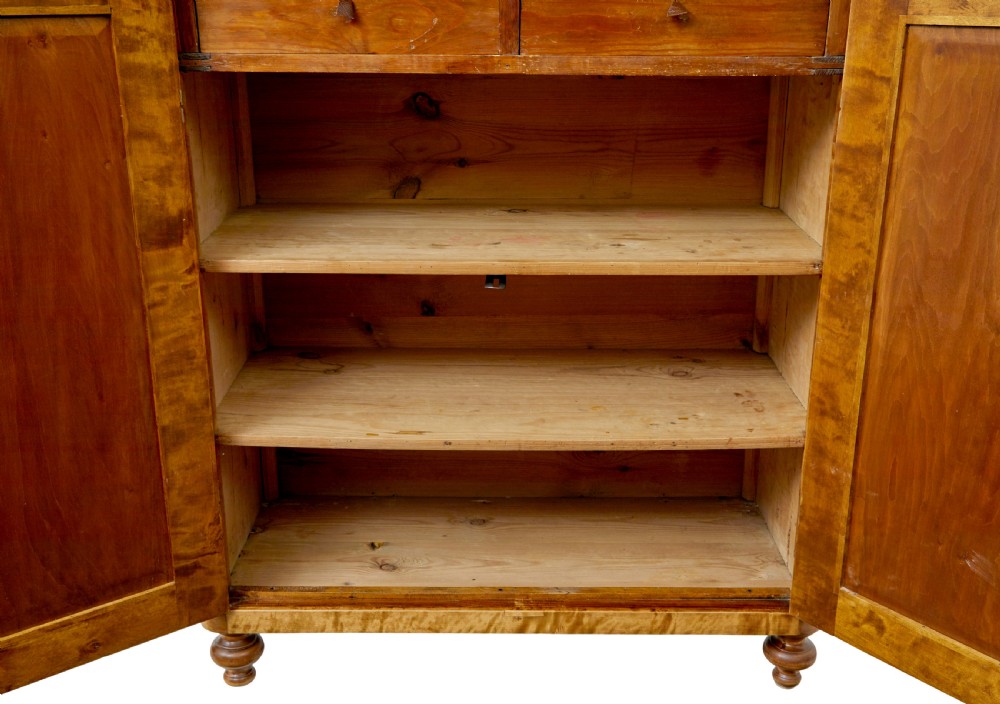 A 19th-century Swedish double-door cupboard crafted from highly figured golden birch timber with turned front feet. View VIII