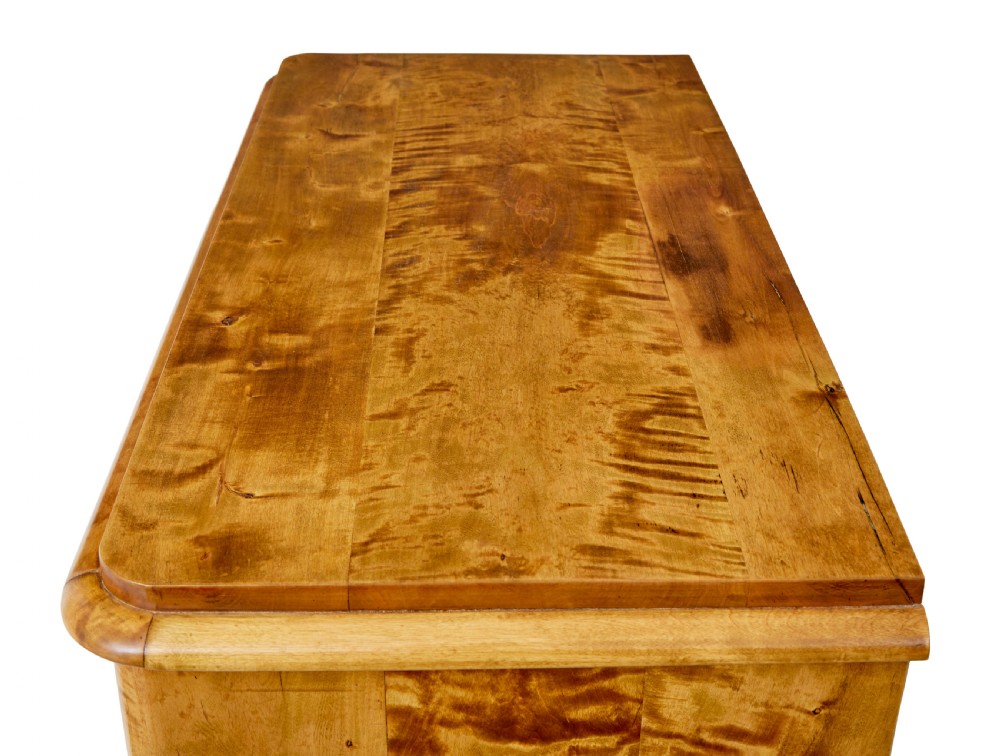 A 19th-century Swedish double-door cupboard crafted from highly figured golden birch timber with turned front feet. View X