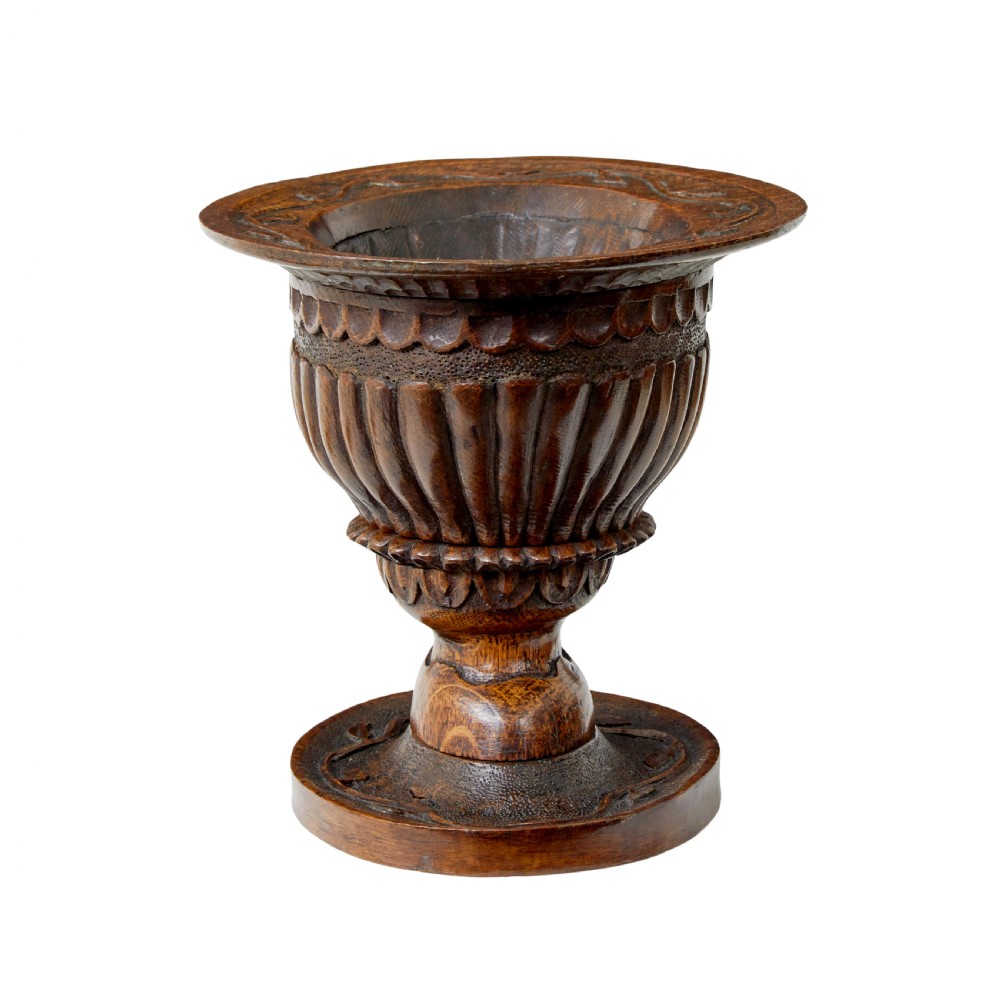 A 19th-century carved oak pedestal bowl featuring deep fluted sides, carved scrollwork along the rim, and a turned circular base. View II