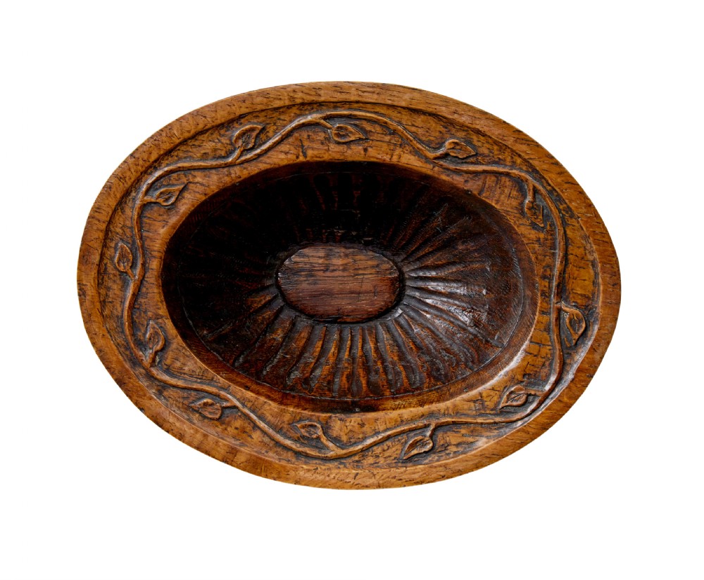 A 19th-century carved oak pedestal bowl featuring deep fluted sides, carved scrollwork along the rim, and a turned circular base. View V