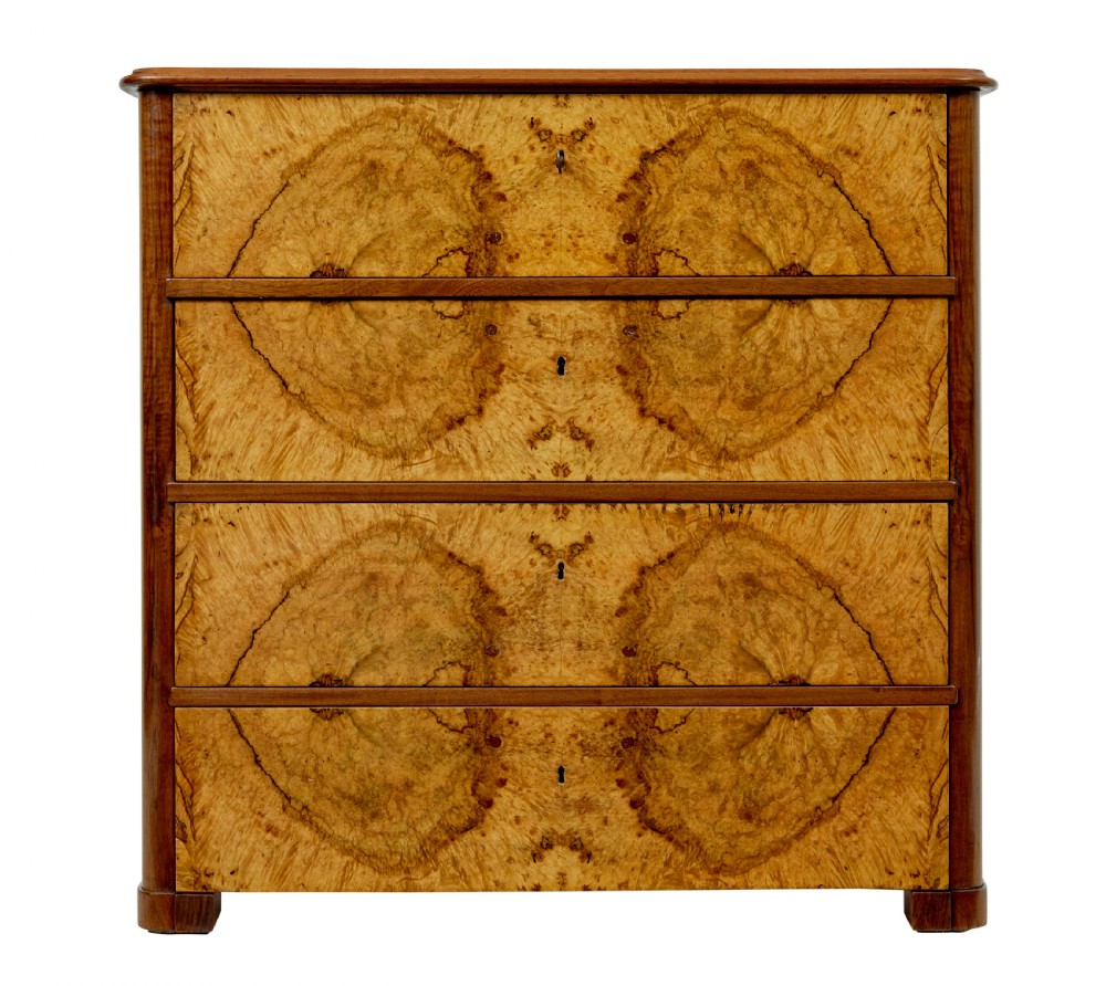 A nineteenth-century Scandinavian burr walnut chest of four drawers featuring symmetrical book-matched grain veneer and rounded side pillars on block feet. View II