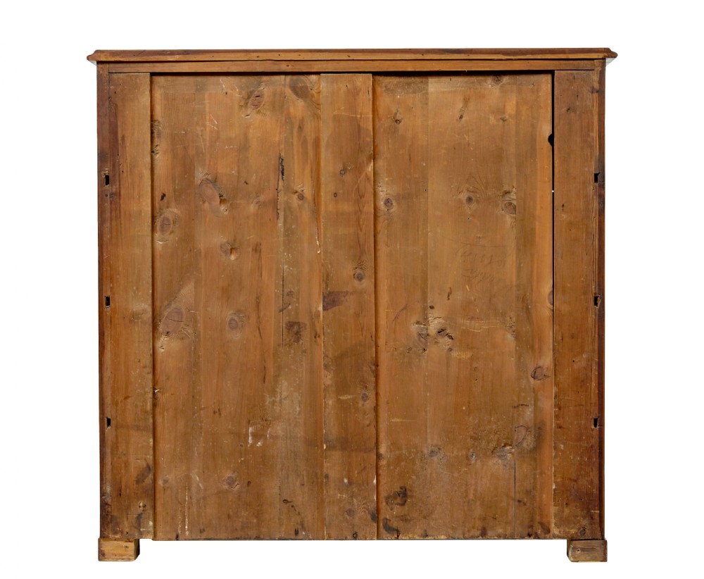 A nineteenth-century Scandinavian burr walnut chest of four drawers featuring symmetrical book-matched grain veneer and rounded side pillars on block feet. View VI