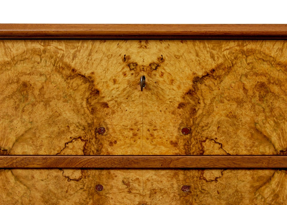 A nineteenth-century Scandinavian burr walnut chest of four drawers featuring symmetrical book-matched grain veneer and rounded side pillars on block feet. View VIII
