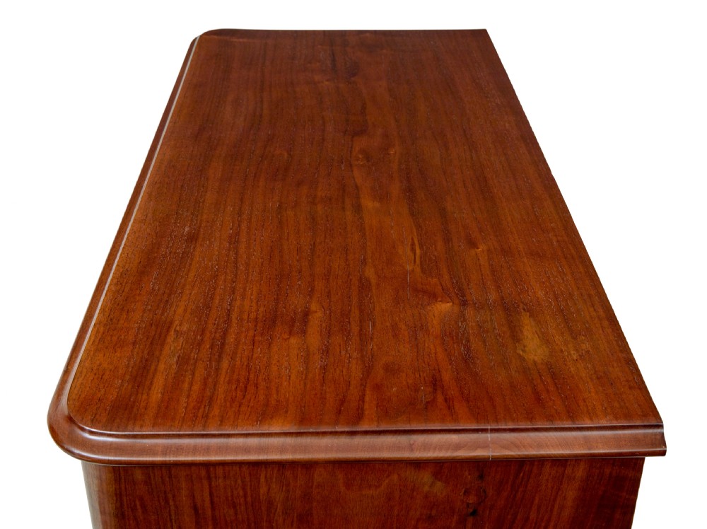 A nineteenth-century Scandinavian burr walnut chest of four drawers featuring symmetrical book-matched grain veneer and rounded side pillars on block feet. View IX