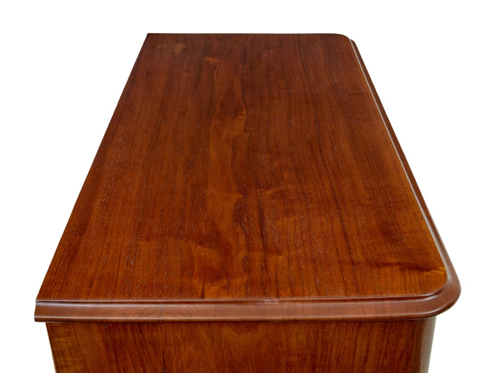A nineteenth-century Scandinavian burr walnut chest of four drawers featuring symmetrical book-matched grain veneer and rounded side pillars on block feet. View X