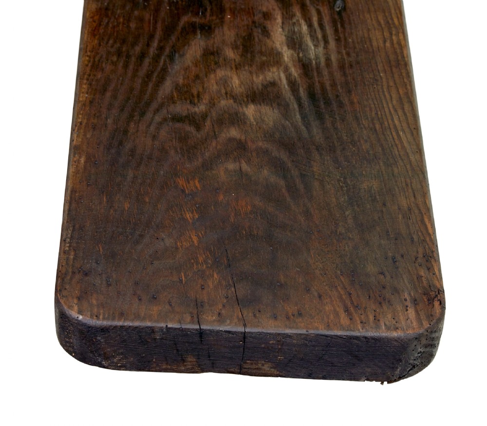 A pair of long early twentieth-century dark pine wooden benches with trestle-style legs. View VI