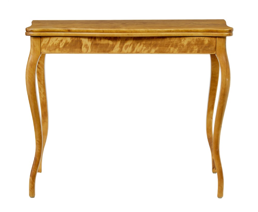 A 19th-century Swedish Rococo Revival tea table crafted from highly figured golden birch with cabriole legs and a fold-over top. View II