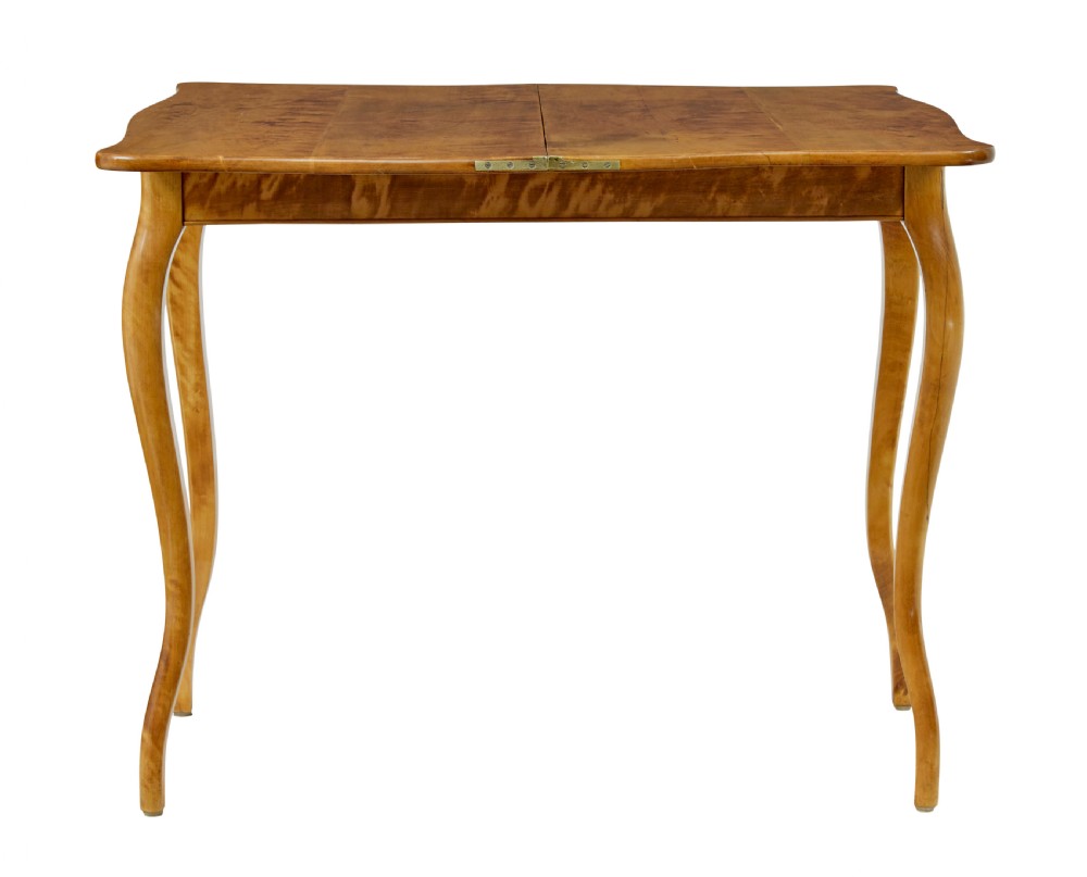 A 19th-century Swedish Rococo Revival tea table crafted from highly figured golden birch with cabriole legs and a fold-over top. View IV