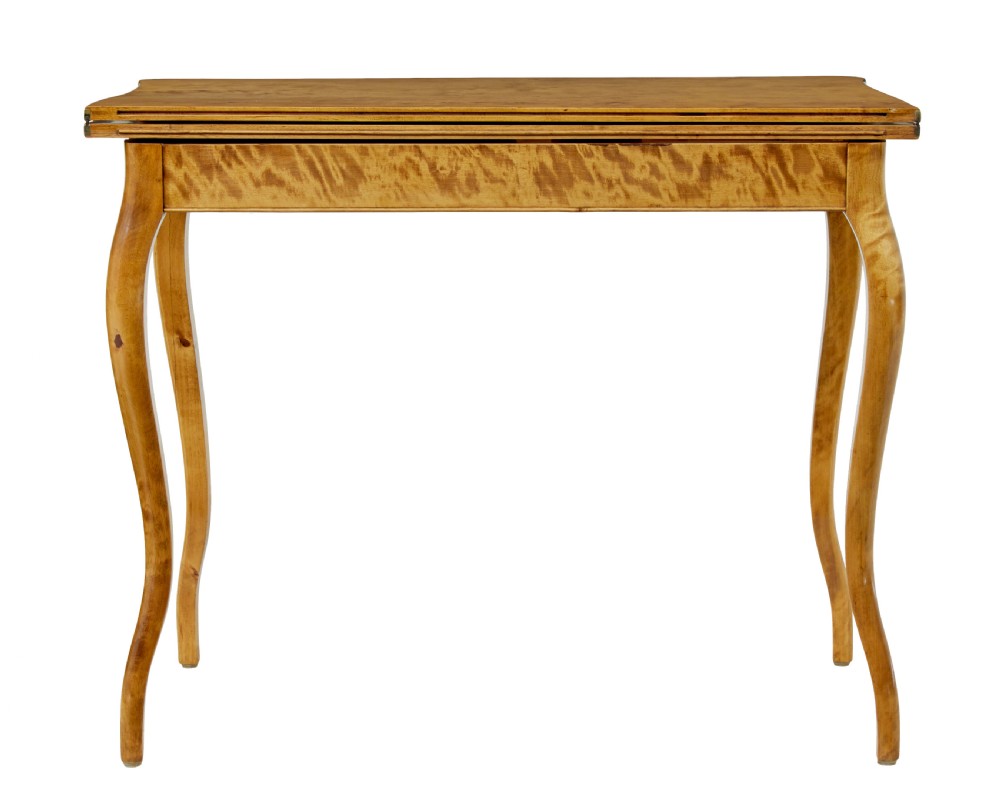 A 19th-century Swedish Rococo Revival tea table crafted from highly figured golden birch with cabriole legs and a fold-over top. View VII