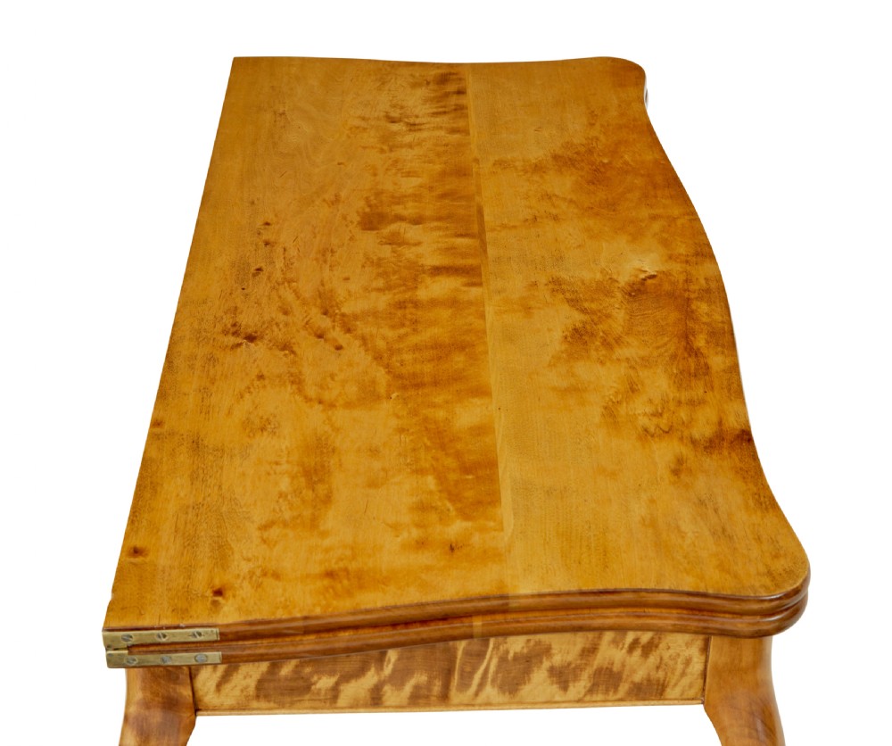 A 19th-century Swedish Rococo Revival tea table crafted from highly figured golden birch with cabriole legs and a fold-over top. View VIII