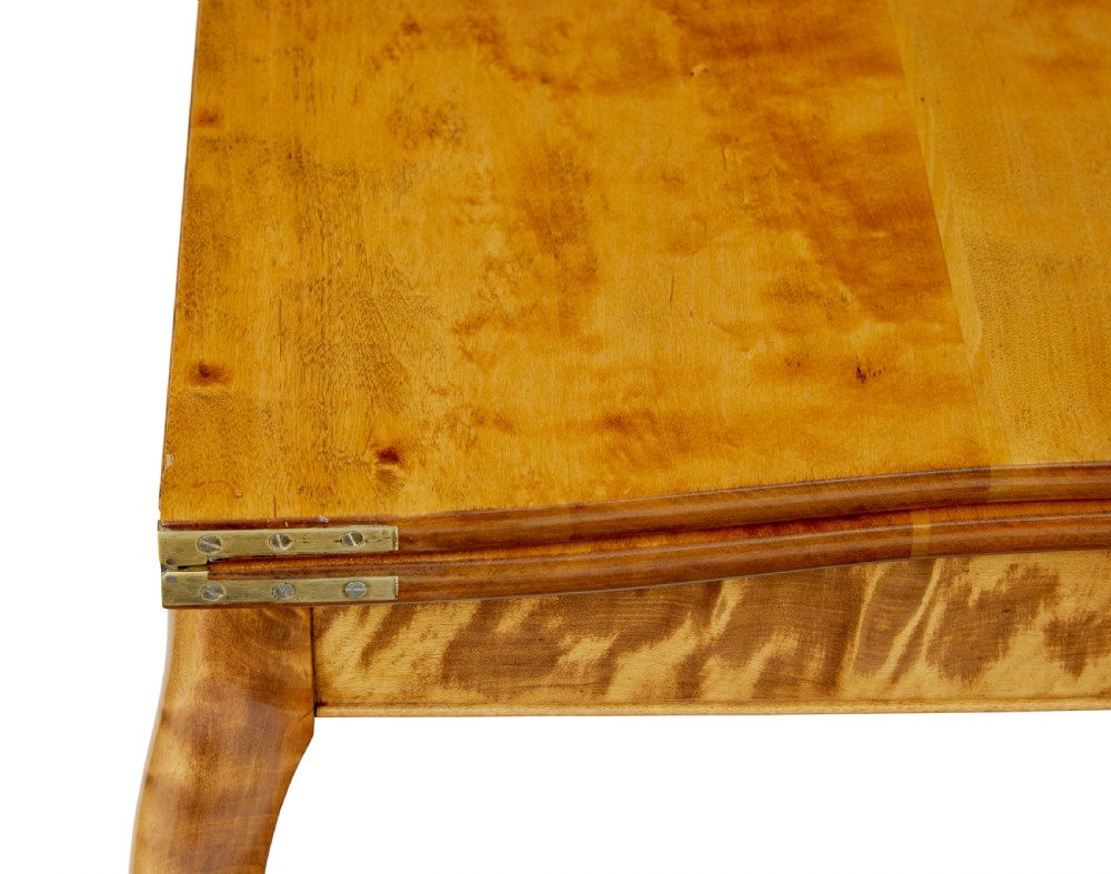 A 19th-century Swedish Rococo Revival tea table crafted from highly figured golden birch with cabriole legs and a fold-over top. View IX