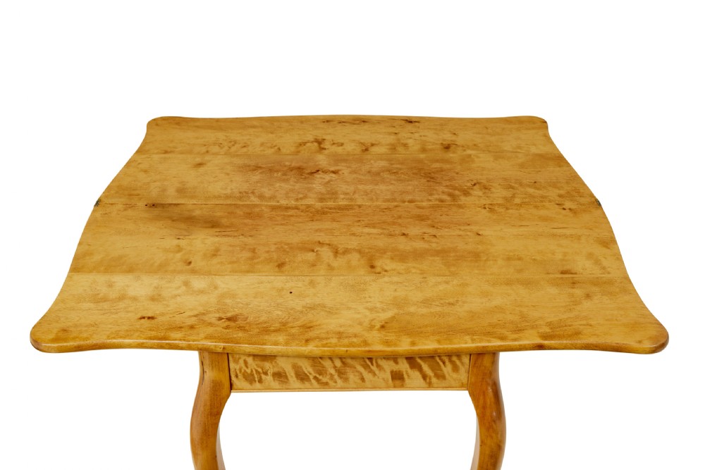 A 19th-century Swedish Rococo Revival tea table crafted from highly figured golden birch with cabriole legs and a fold-over top. View XI