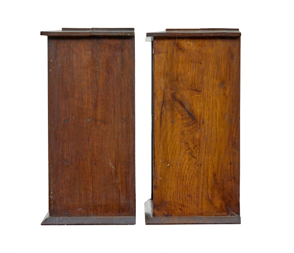 A pair of antique warm brown oak tabletop cabinets featuring glazed doors, brass keyhole escutcheons, and two internal drawers with decorative brass handles. View III