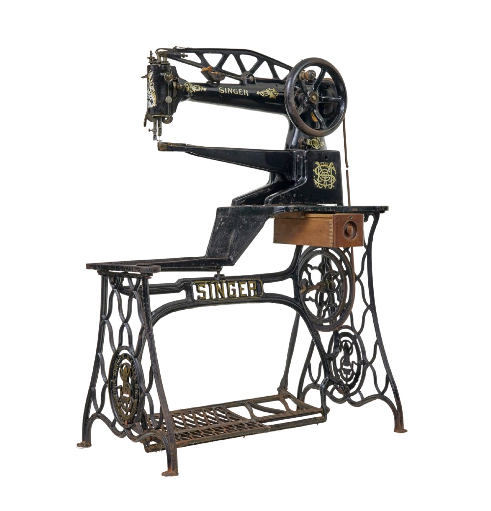 A 19th-century black cast iron Singer industrial treadle sewing machine with openwork frame and gilded lettering. View II