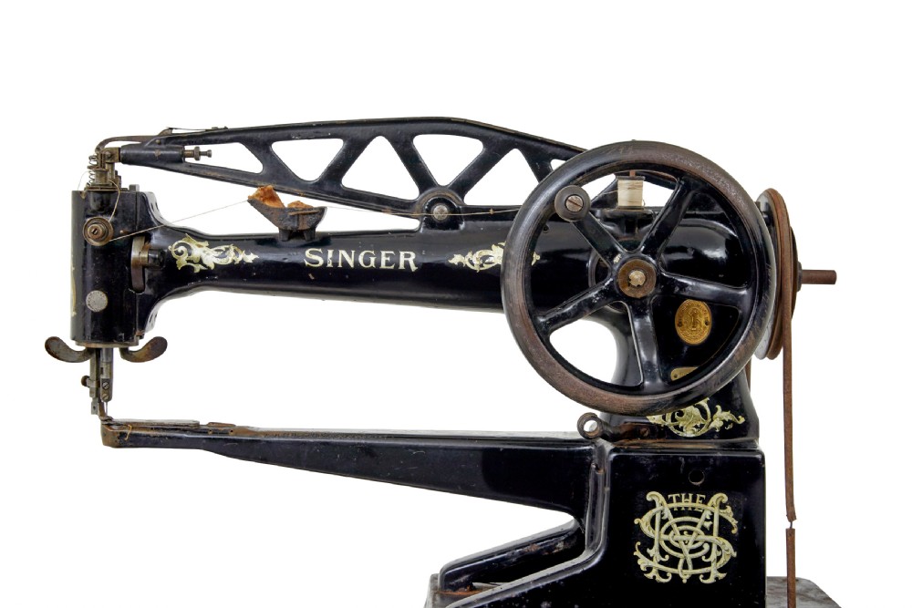 A 19th-century black cast iron Singer industrial treadle sewing machine with openwork frame and gilded lettering. View VII