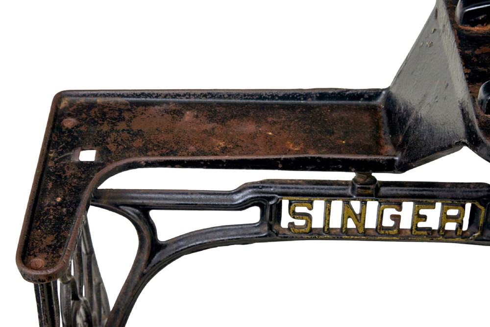 A 19th-century black cast iron Singer industrial treadle sewing machine with openwork frame and gilded lettering. View XI