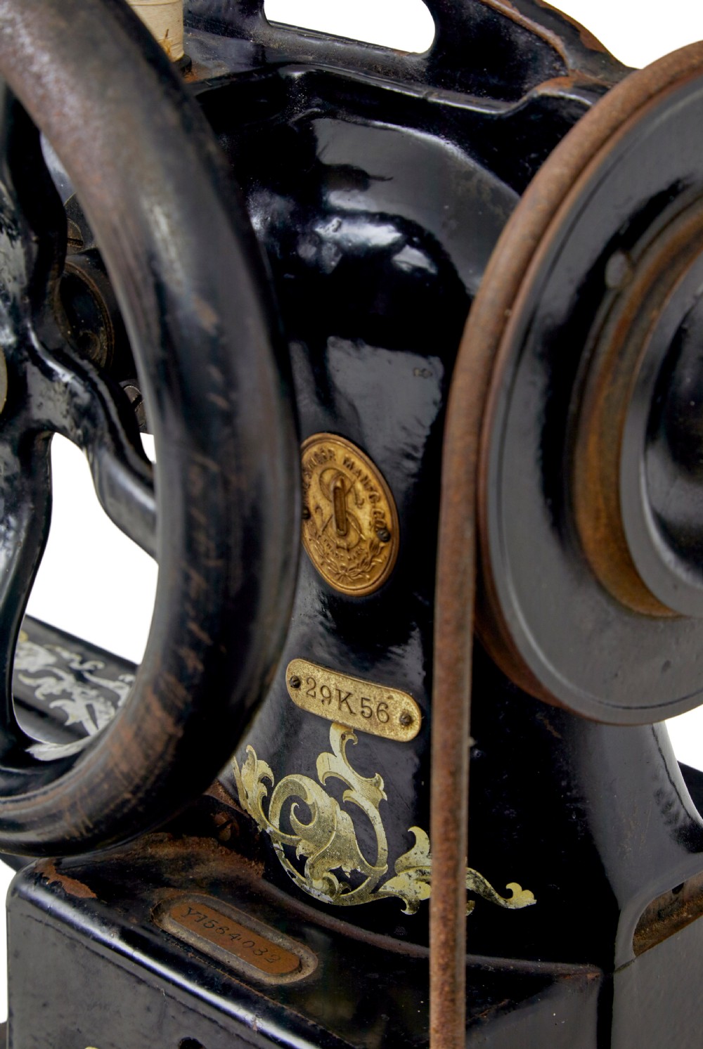 A 19th-century black cast iron Singer industrial treadle sewing machine with openwork frame and gilded lettering. View XII
