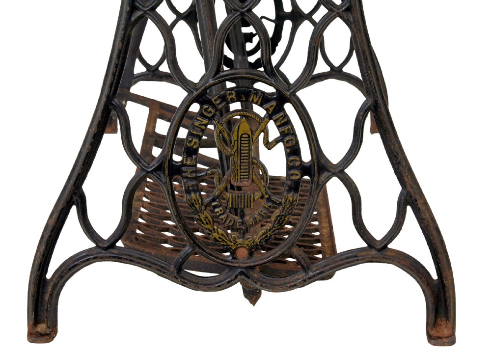 A 19th-century black cast iron Singer industrial treadle sewing machine with openwork frame and gilded lettering. View XIII