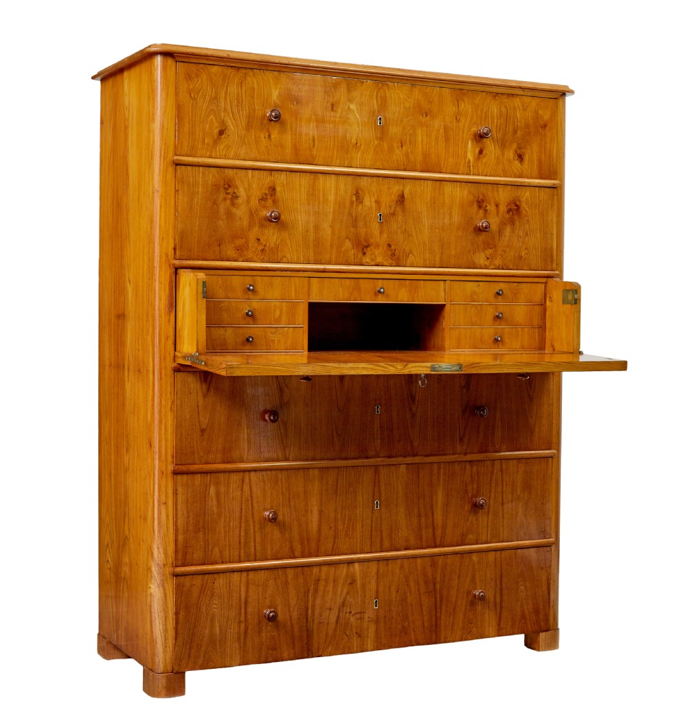 A tall 19th-century elm secretaire chest featuring six graduated drawers with turned wooden knobs and keyhole escutcheons. View II