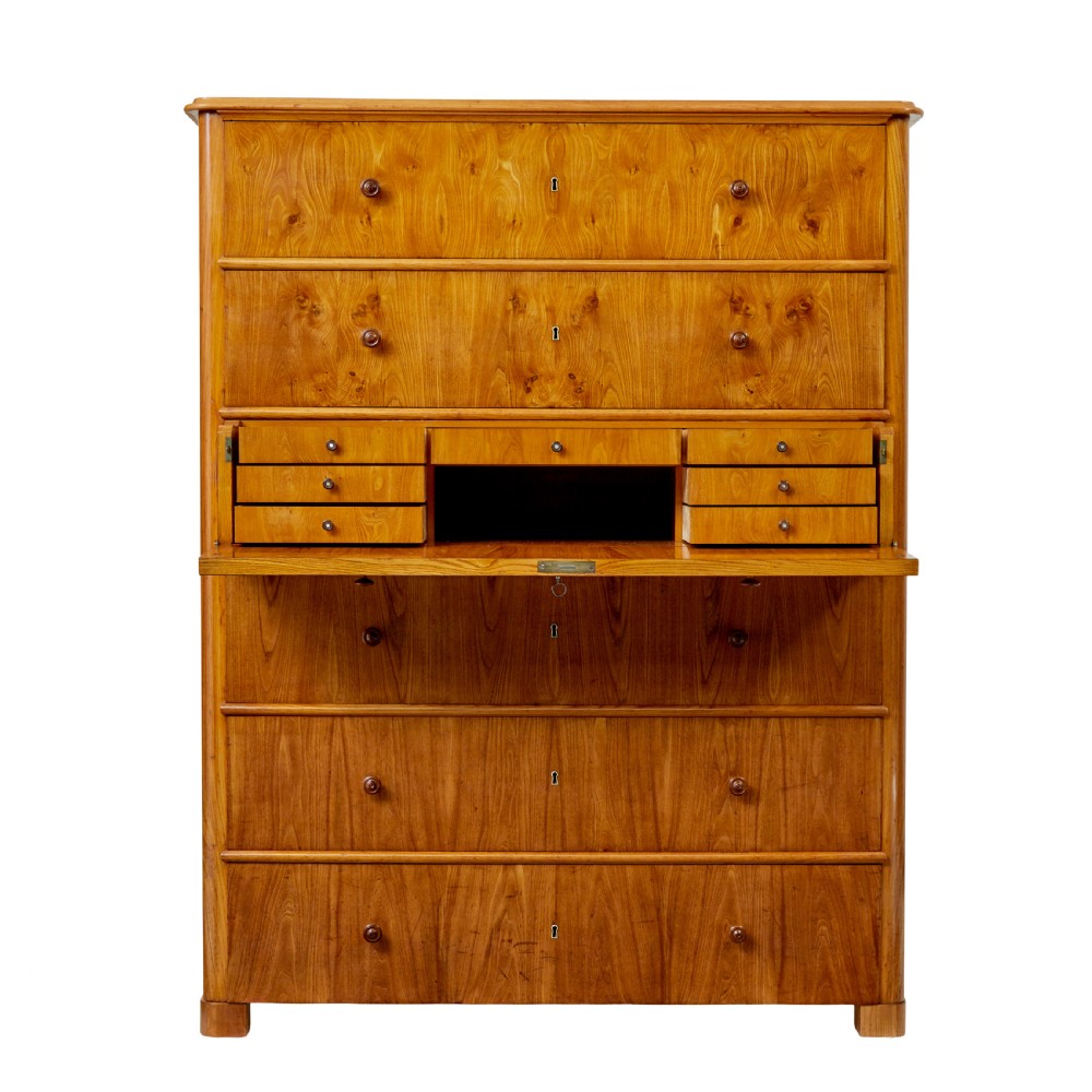 A tall 19th-century elm secretaire chest featuring six graduated drawers with turned wooden knobs and keyhole escutcheons. View V