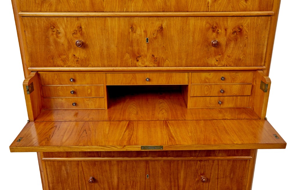 A tall 19th-century elm secretaire chest featuring six graduated drawers with turned wooden knobs and keyhole escutcheons. View IX