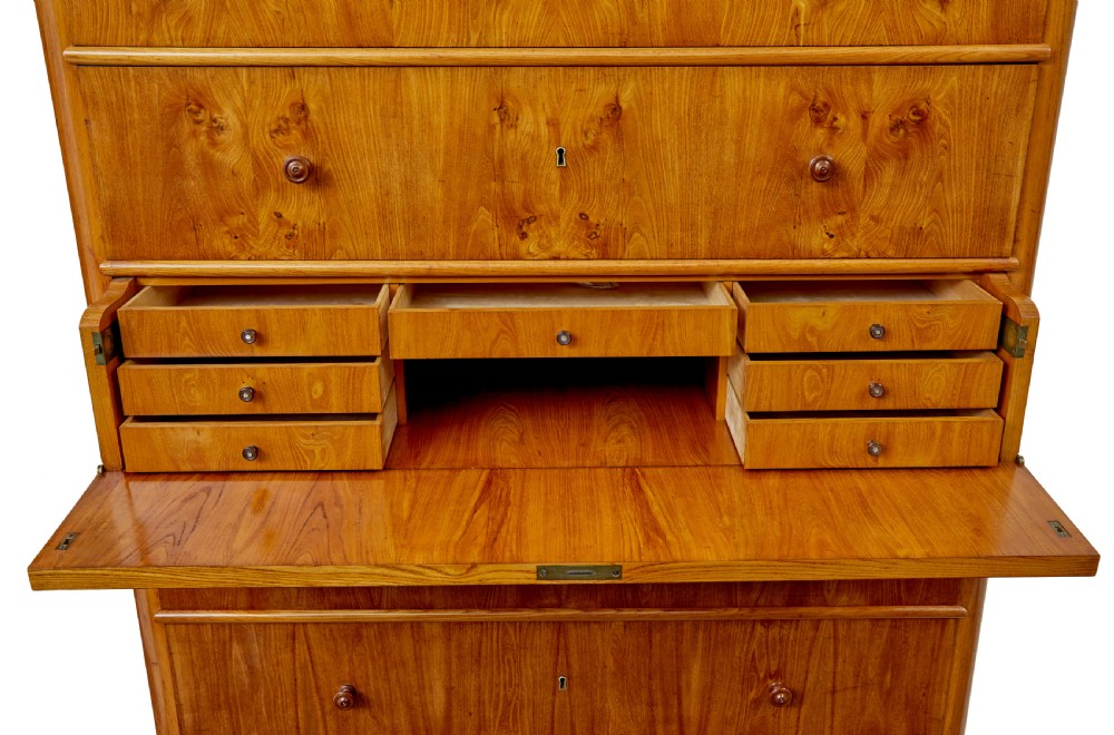 A tall 19th-century elm secretaire chest featuring six graduated drawers with turned wooden knobs and keyhole escutcheons. View X