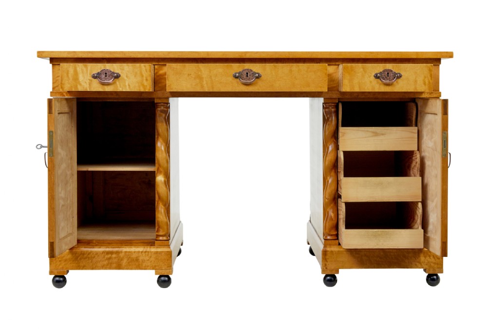 A Swedish early 20th-century pedestal desk crafted from golden flame birch wood featuring barley twist corner columns and spherical black feet. View III