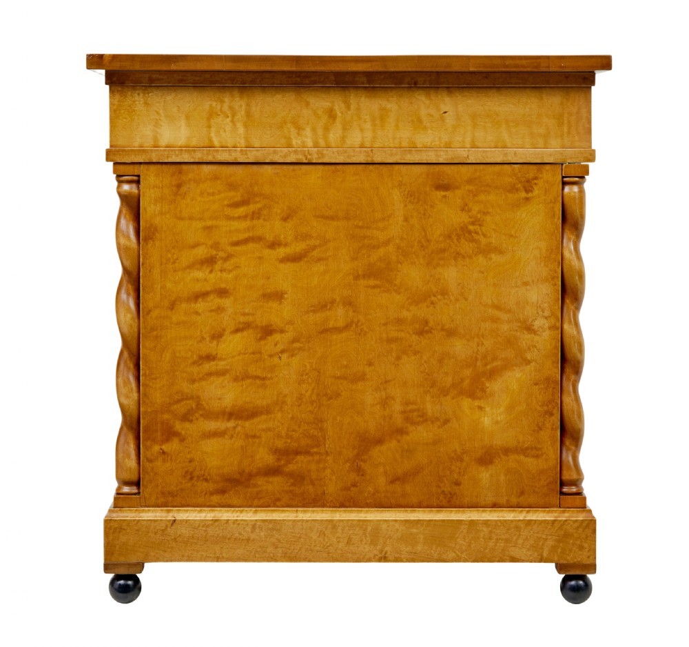 A Swedish early 20th-century pedestal desk crafted from golden flame birch wood featuring barley twist corner columns and spherical black feet. View VII