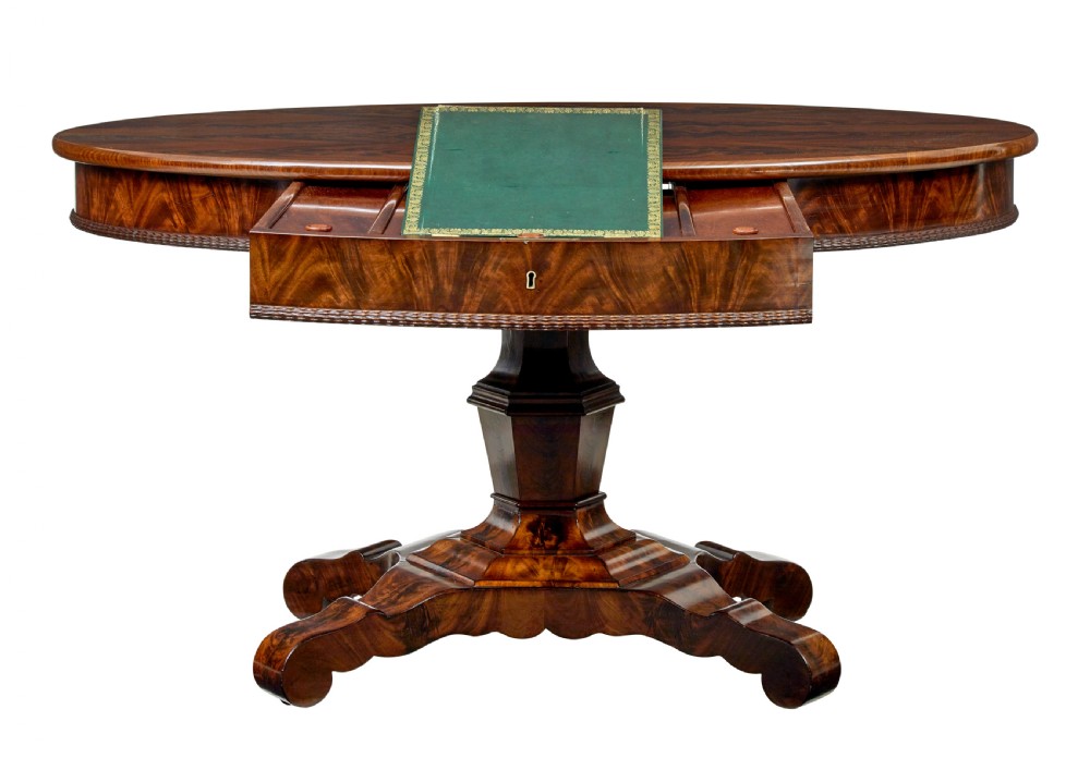 A circular mid-19th-century flame mahogany centre table featuring a frieze drawer, supported by an octagonal pedestal stem and a quadruped scroll-foot base. View II