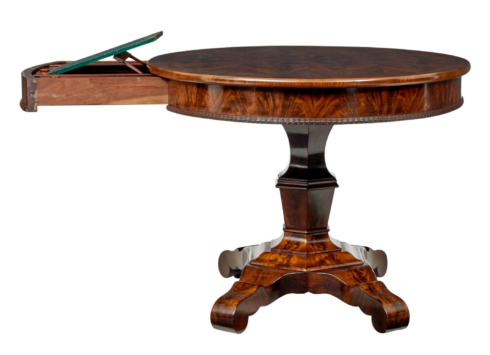A circular mid-19th-century flame mahogany centre table featuring a frieze drawer, supported by an octagonal pedestal stem and a quadruped scroll-foot base. View III