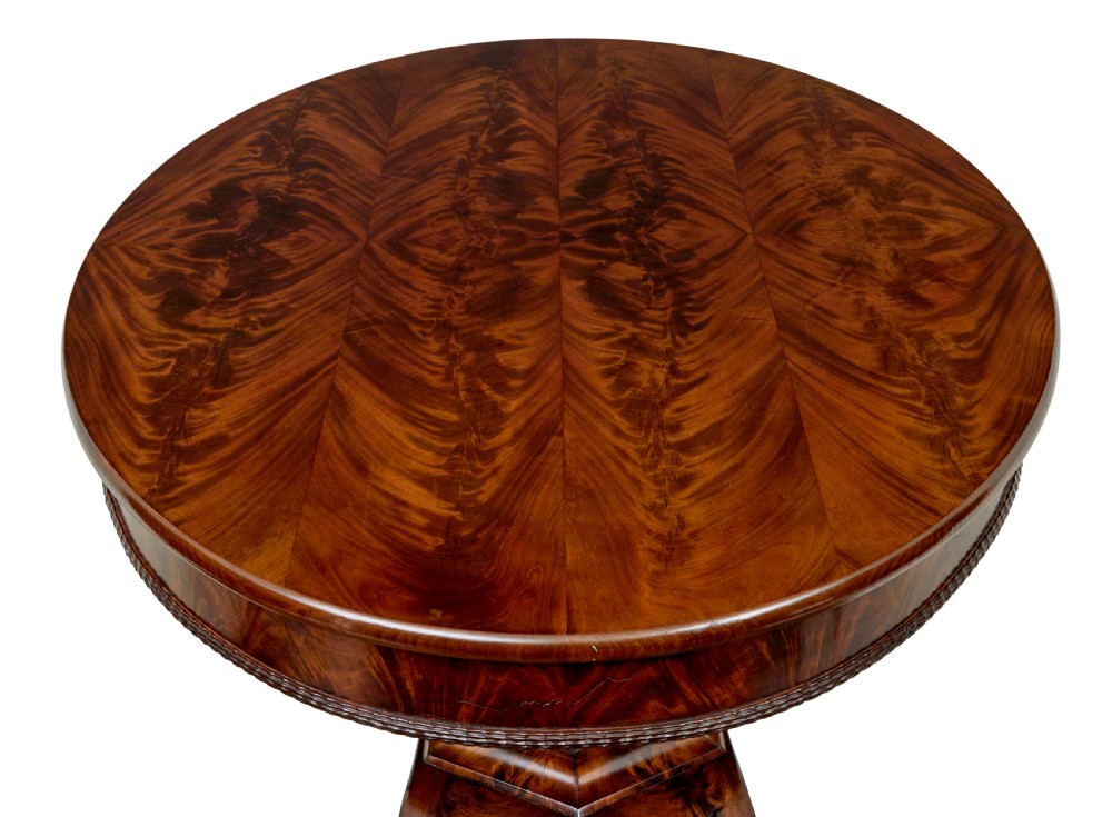 A circular mid-19th-century flame mahogany centre table featuring a frieze drawer, supported by an octagonal pedestal stem and a quadruped scroll-foot base. View VI