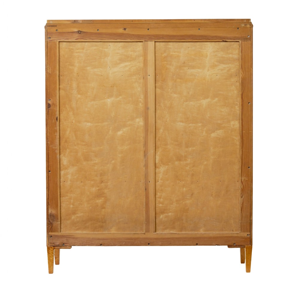 An early 20th-century Swedish Grace satin birch open bookcase featuring a small glazed upper door, open shelving, and a double-door lower cabinet with oval panelling. View VI