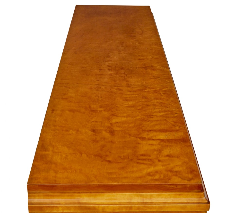 An early 20th-century Swedish Grace satin birch open bookcase featuring a small glazed upper door, open shelving, and a double-door lower cabinet with oval panelling. View X