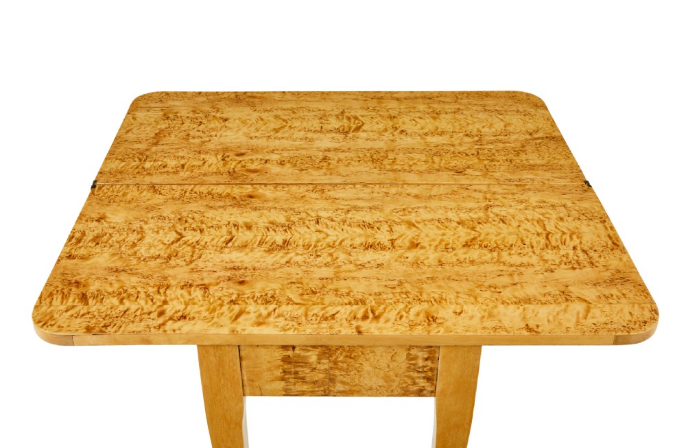 A 19th-century Swedish tea table constructed from warm burr birch veneer featuring slender tapered legs and a folding rectangular top. View IV