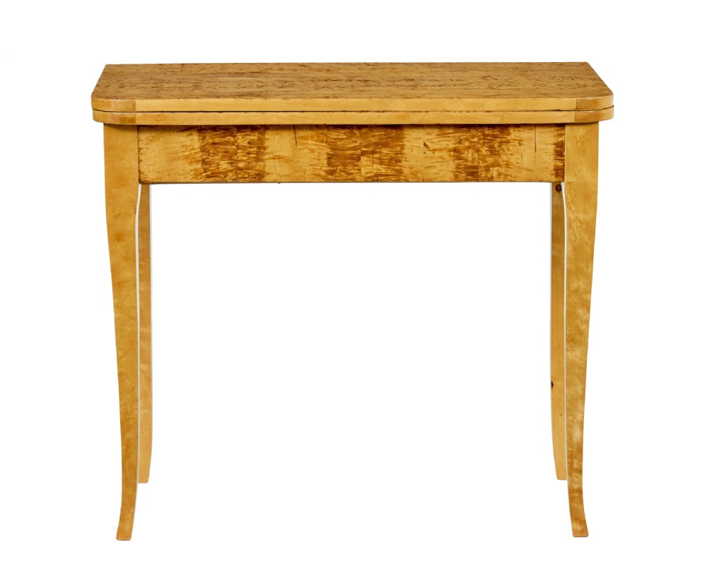 A 19th-century Swedish tea table constructed from warm burr birch veneer featuring slender tapered legs and a folding rectangular top. View VII