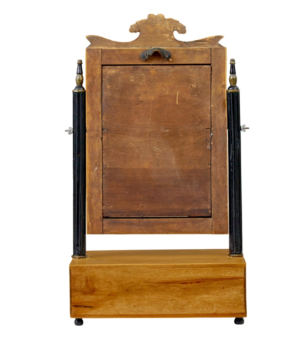 A 19th-century Swedish light birch tabletop vanity mirror featuring a carved top crest, ebonised side columns with brass finials, and a base drawer on bun feet. View III