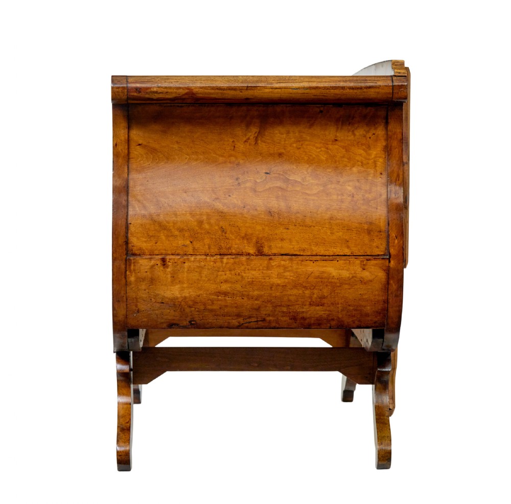 A 19th-century Swedish Empire sofa crafted from golden birch with scrolled ends and splayed legs, featuring geometric pattern textile upholstery. View V