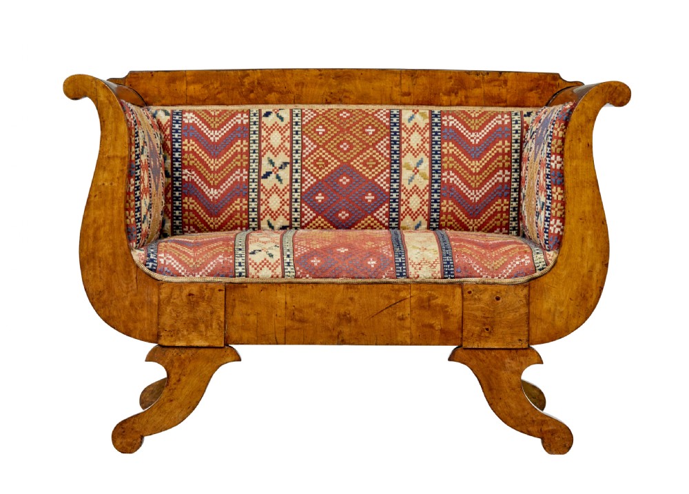 A 19th-century Swedish Empire sofa crafted from golden birch with scrolled ends and splayed legs, featuring geometric pattern textile upholstery. View VI