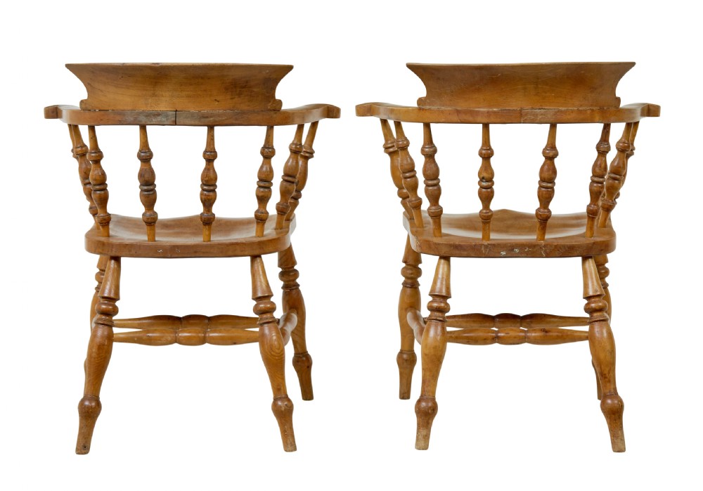 A pair of 19th-century light brown elm elbow chairs featuring curved crest rails, turned spindle backs, shaped saddle seats, and turned legs. View IV
