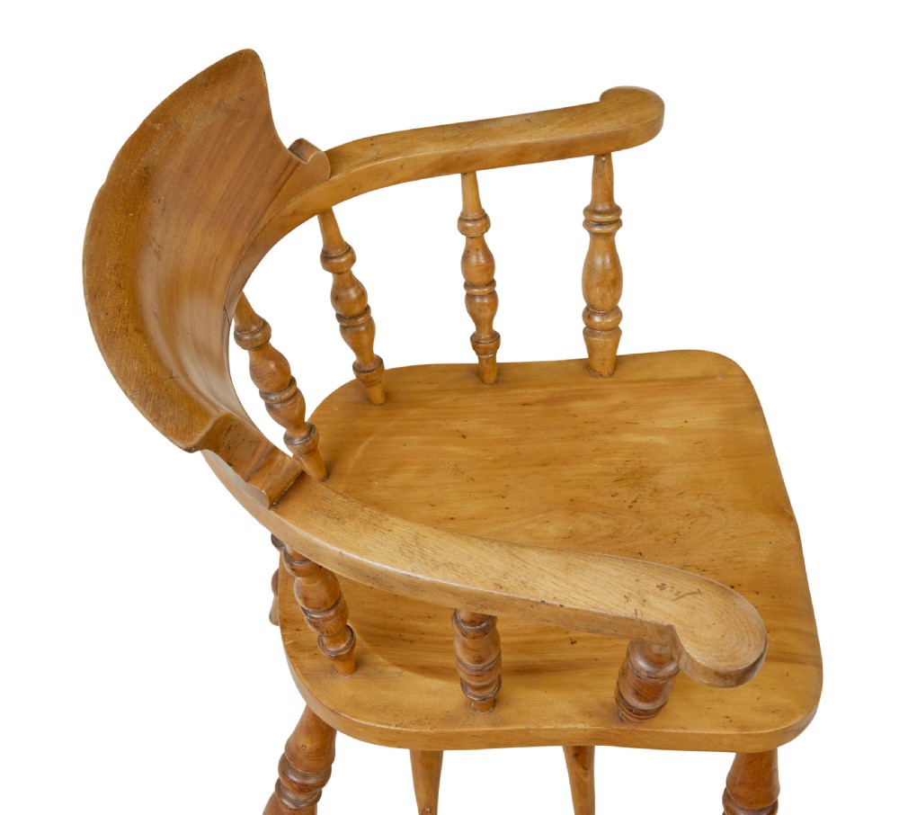 A pair of 19th-century light brown elm elbow chairs featuring curved crest rails, turned spindle backs, shaped saddle seats, and turned legs. View V