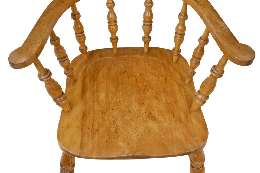 A pair of 19th-century light brown elm elbow chairs featuring curved crest rails, turned spindle backs, shaped saddle seats, and turned legs. View VI