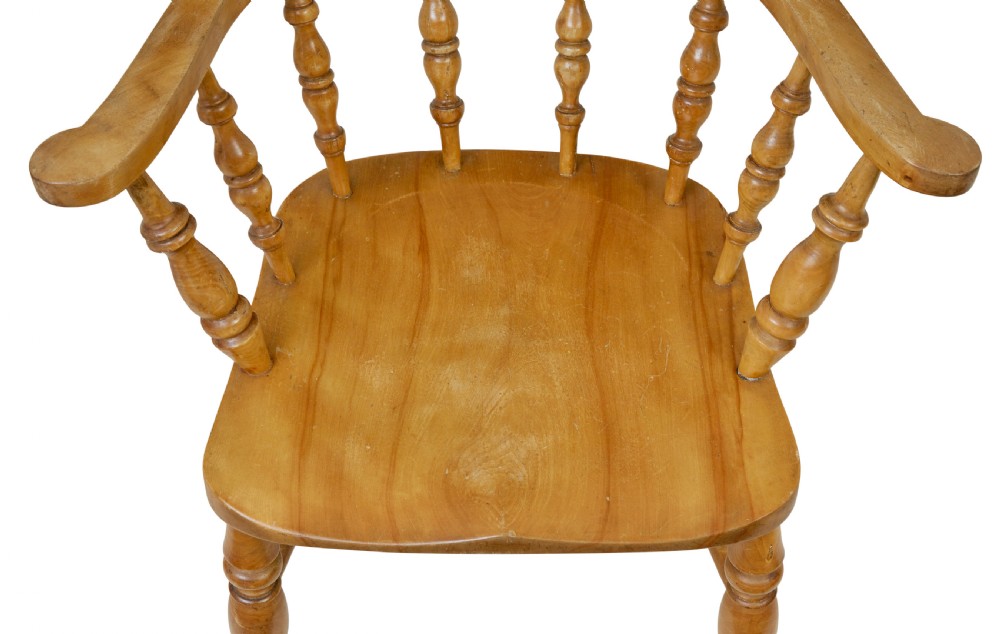 A pair of 19th-century light brown elm elbow chairs featuring curved crest rails, turned spindle backs, shaped saddle seats, and turned legs. View VII