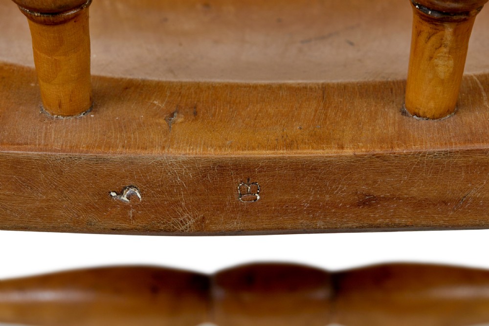 A pair of 19th-century light brown elm elbow chairs featuring curved crest rails, turned spindle backs, shaped saddle seats, and turned legs. View VIII