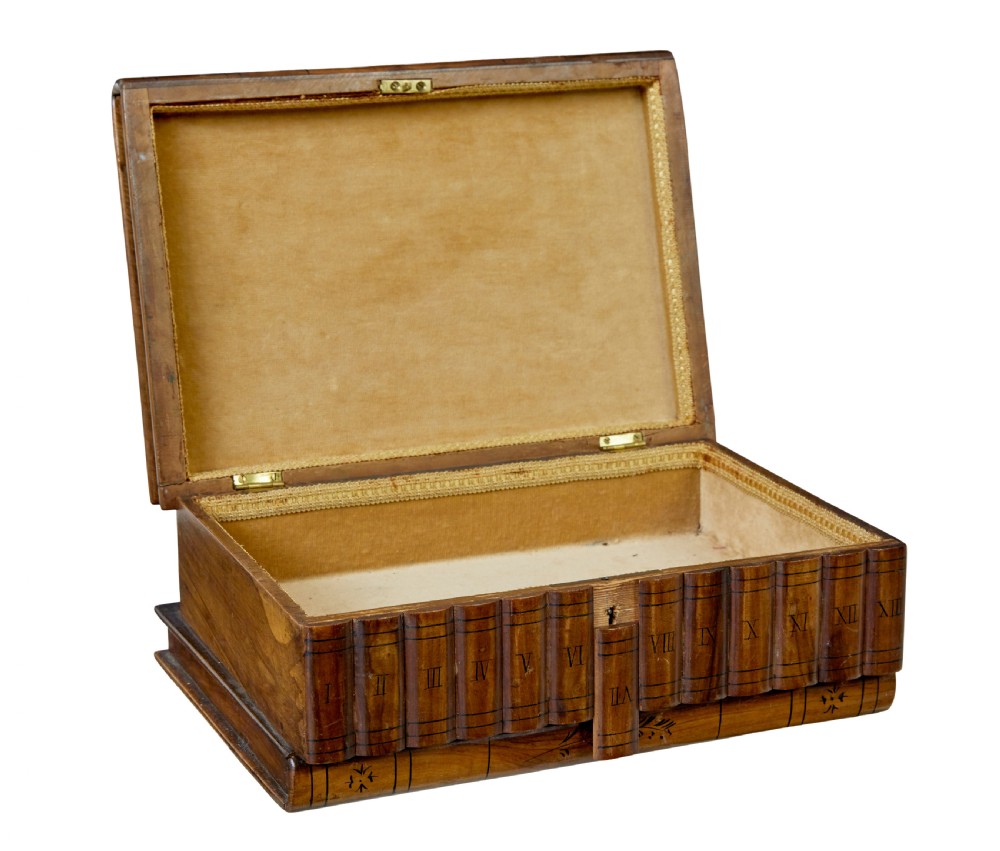A 19th-century olive wood box crafted in the shape of a stack of books, featuring detailed floral marquetry inlay on the lid and carved book spines on the sides. View II