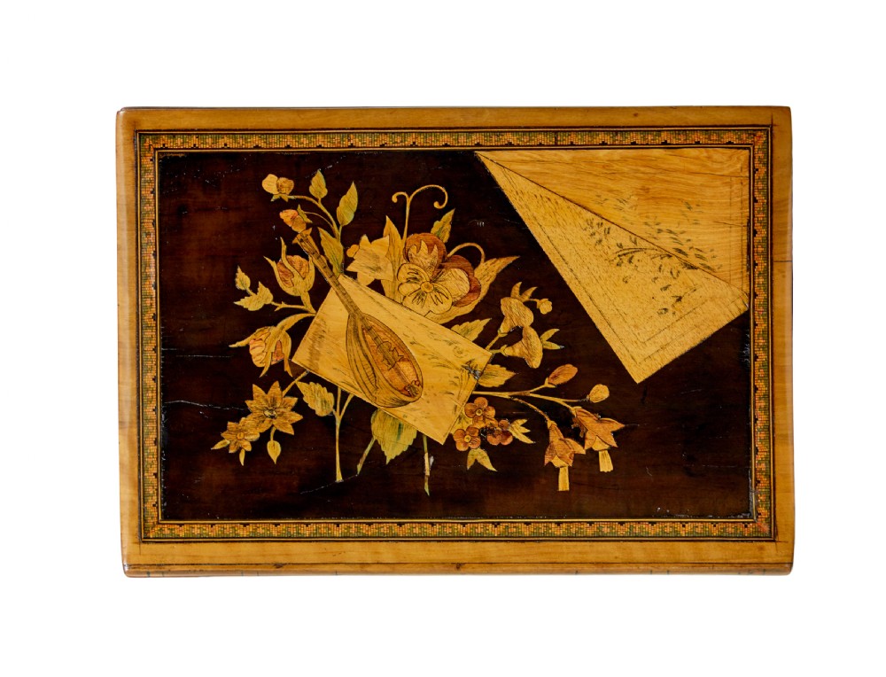 A 19th-century olive wood box crafted in the shape of a stack of books, featuring detailed floral marquetry inlay on the lid and carved book spines on the sides. View VI