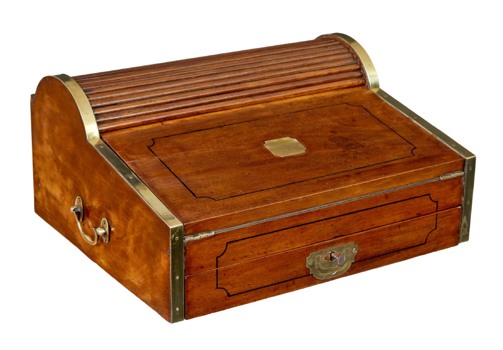 A 19th-century camphor wood campaign writing slope featuring a slatted tambour top, brass corner strapping, side carrying handles, and line inlay details.