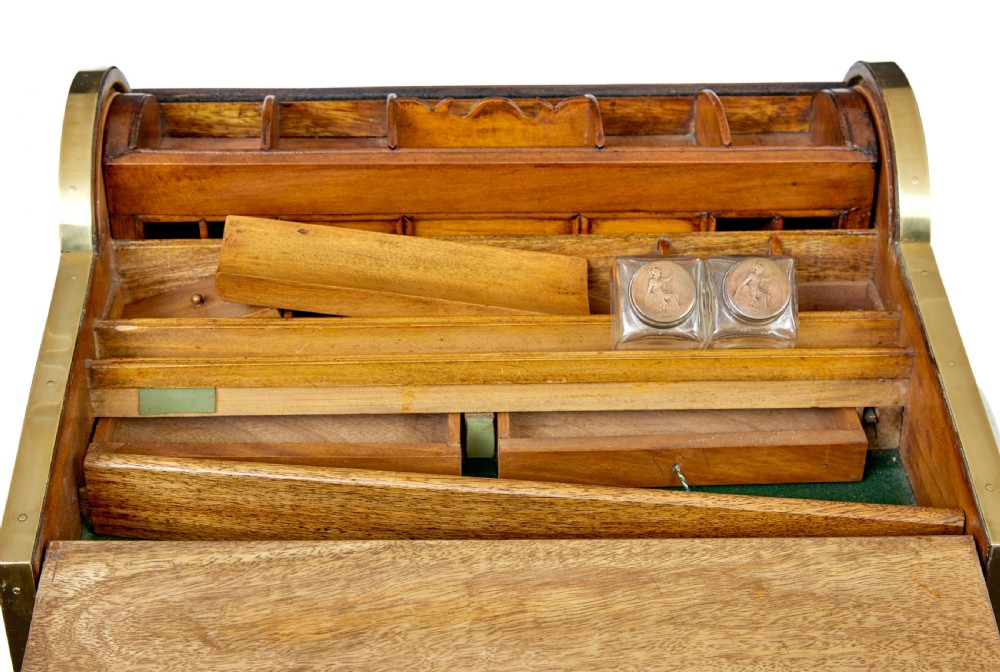 A 19th-century camphor wood campaign writing slope featuring a slatted tambour top, brass corner strapping, side carrying handles, and line inlay details. View V