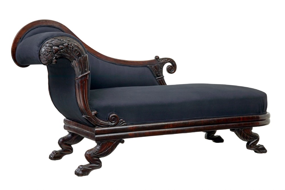 A 19th-century William IV mahogany chaise longue with hand-carved scroll detailing and dark fabric upholstery. View II