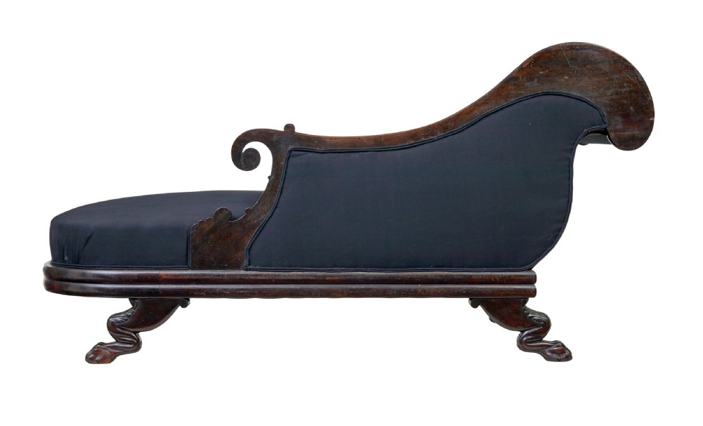 A 19th-century William IV mahogany chaise longue with hand-carved scroll detailing and dark fabric upholstery. View V