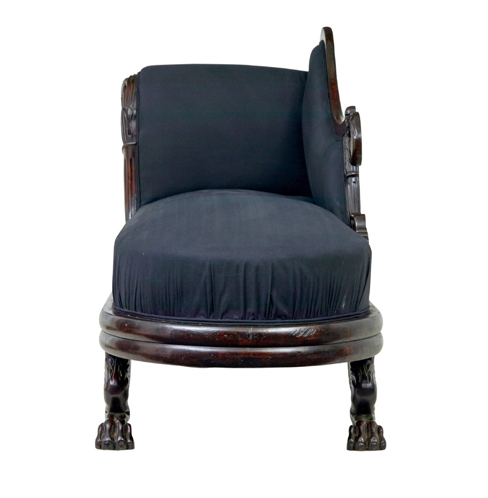 A 19th-century William IV mahogany chaise longue with hand-carved scroll detailing and dark fabric upholstery. View VI